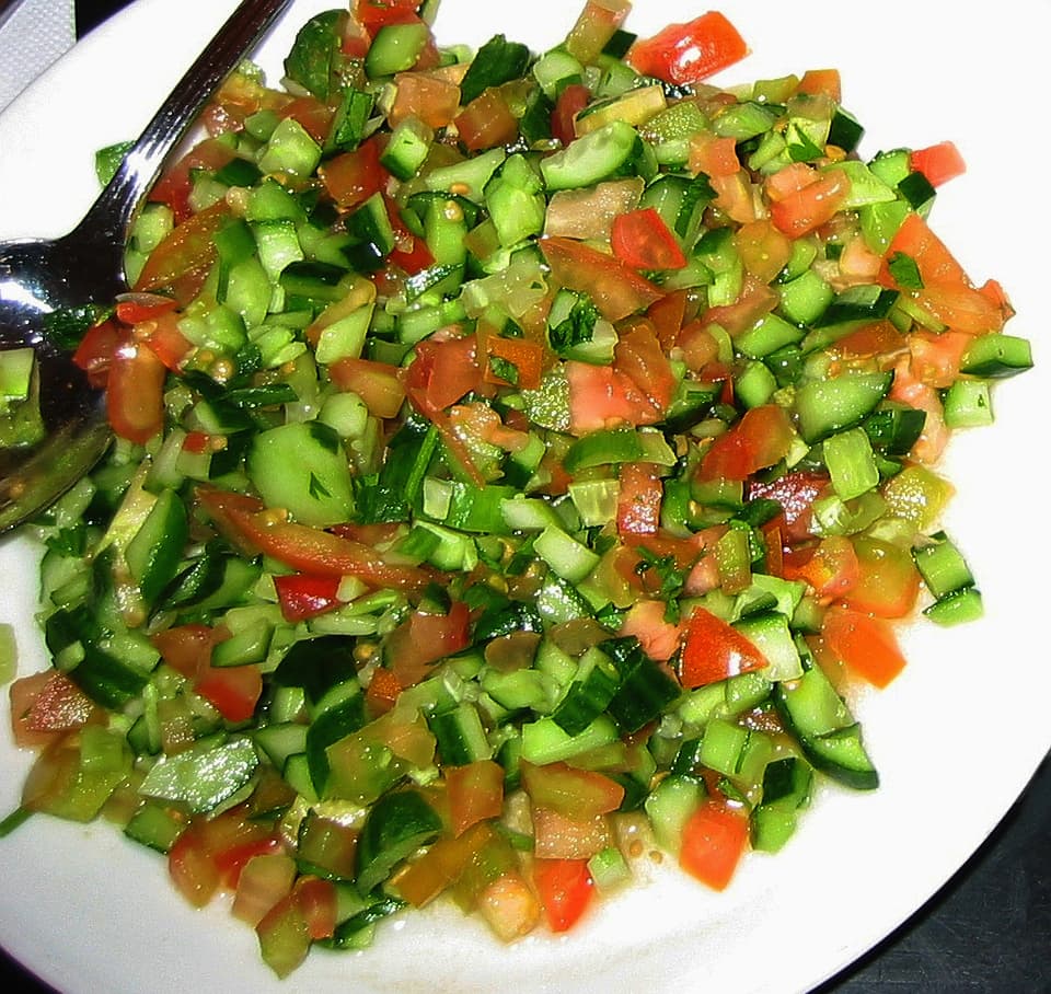Finely diced Israeli salad with cucumber, tomato, and herbs
