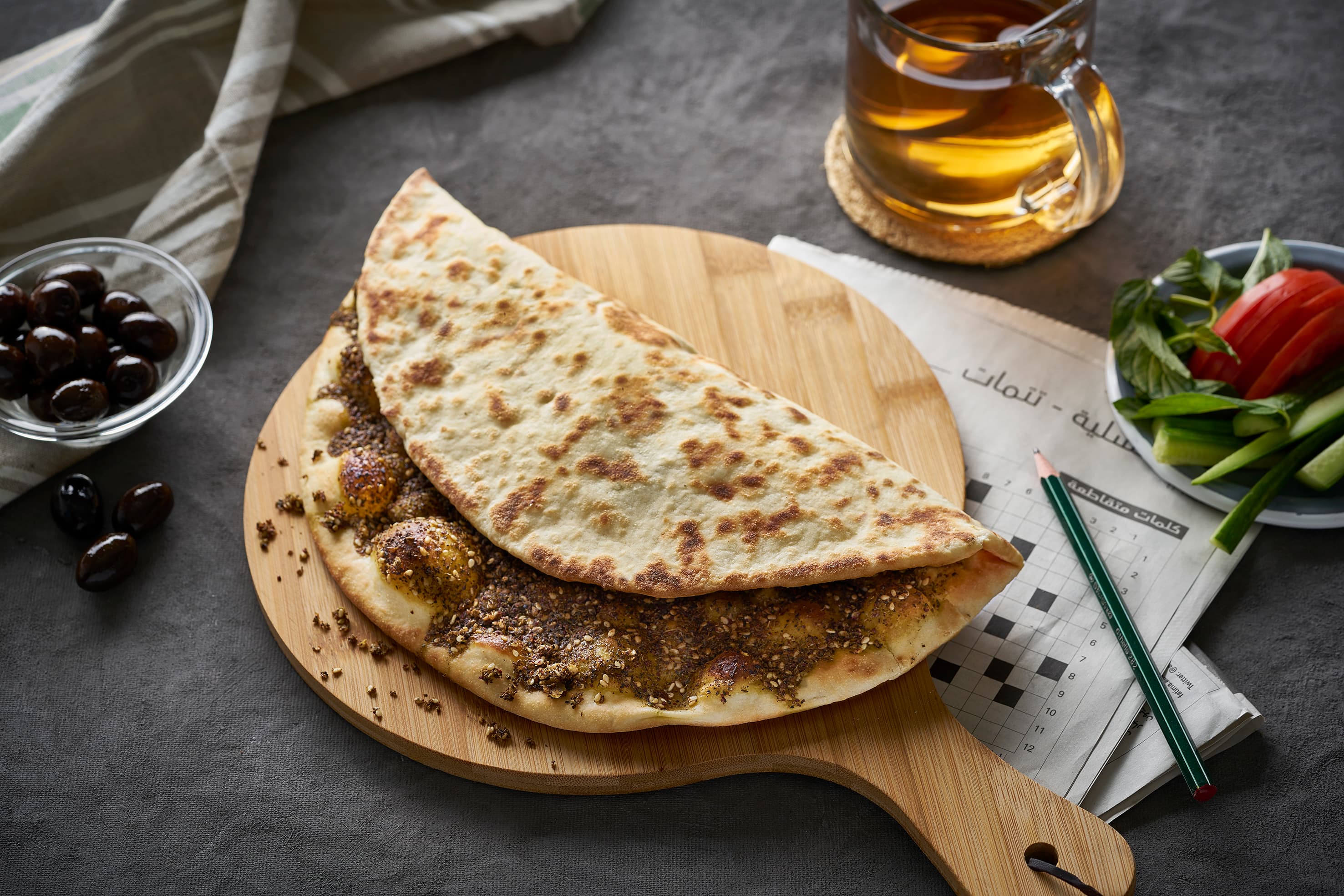 Round manakish flatbread topped with green za'atar and olive oil