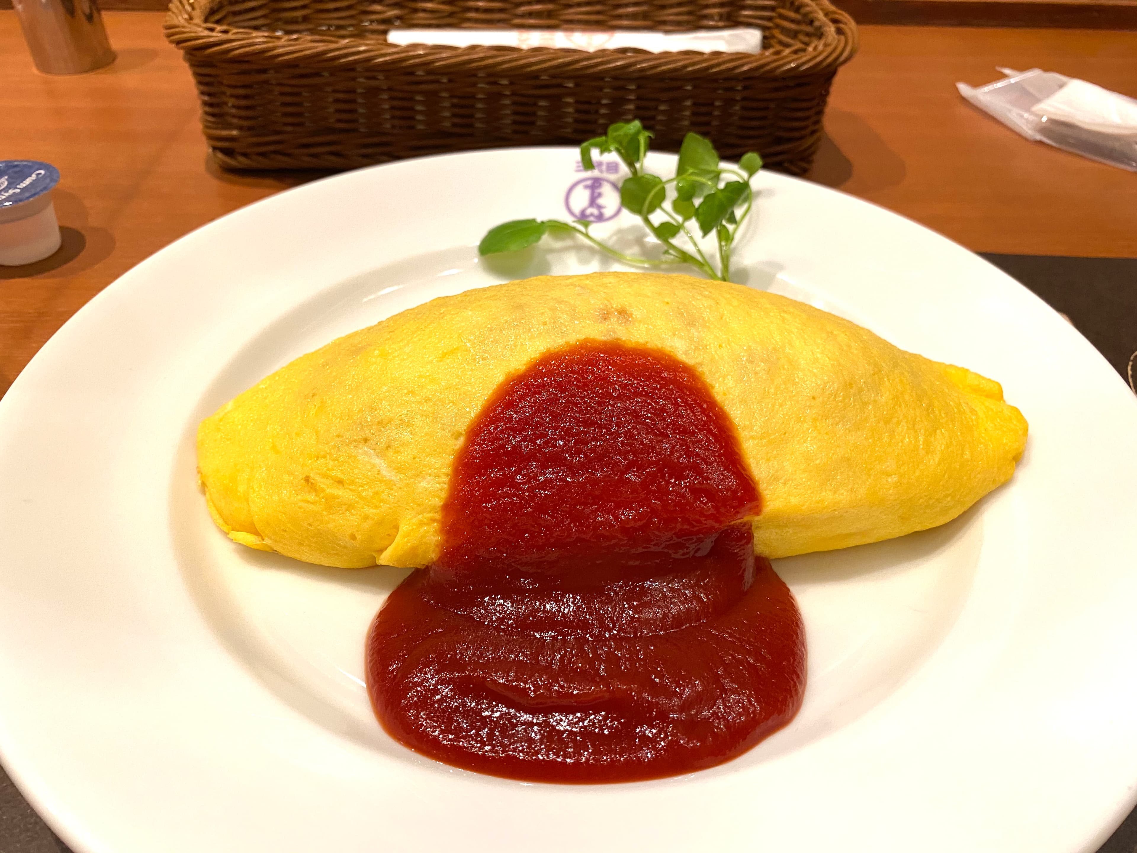Omurice with soft omelet draped over ketchup fried rice