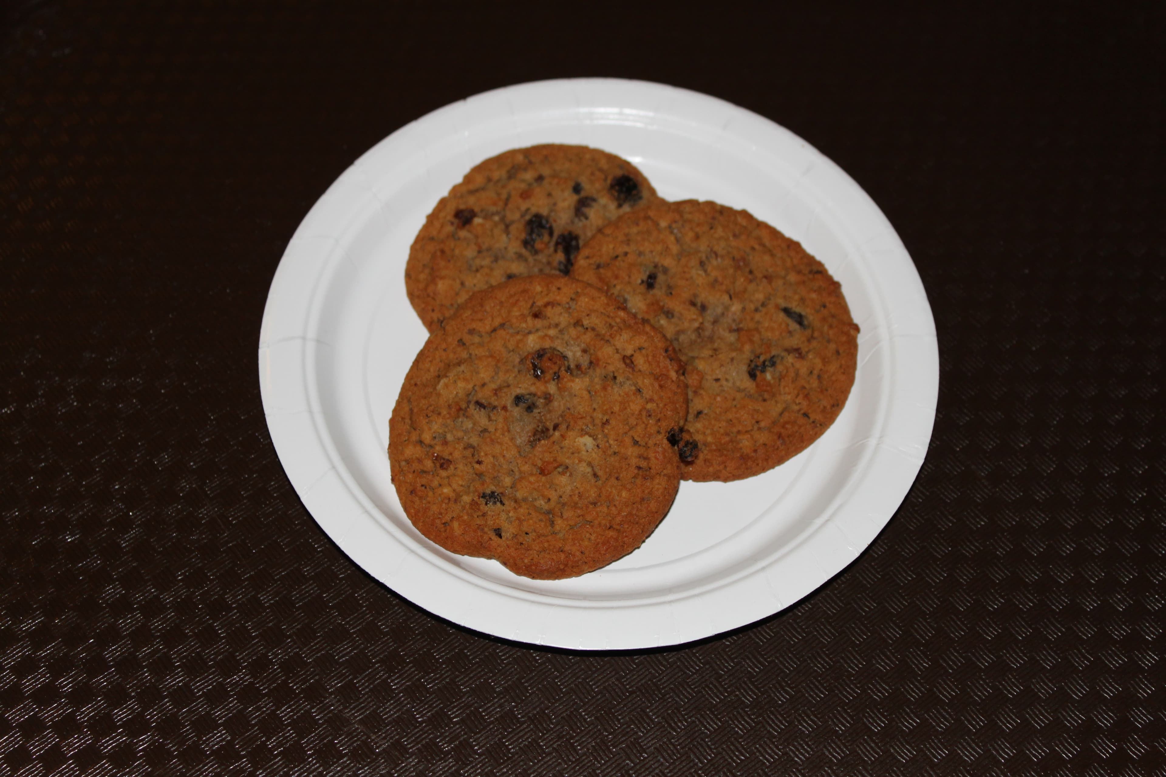 Stack of chewy oatmeal raisin cookies on a wooden board