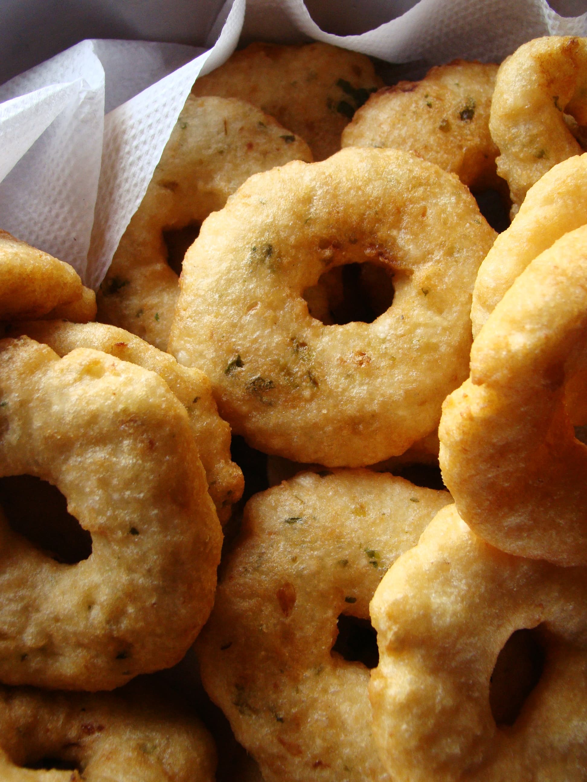 Golden crispy medu vada on a plate with sambar and chutney