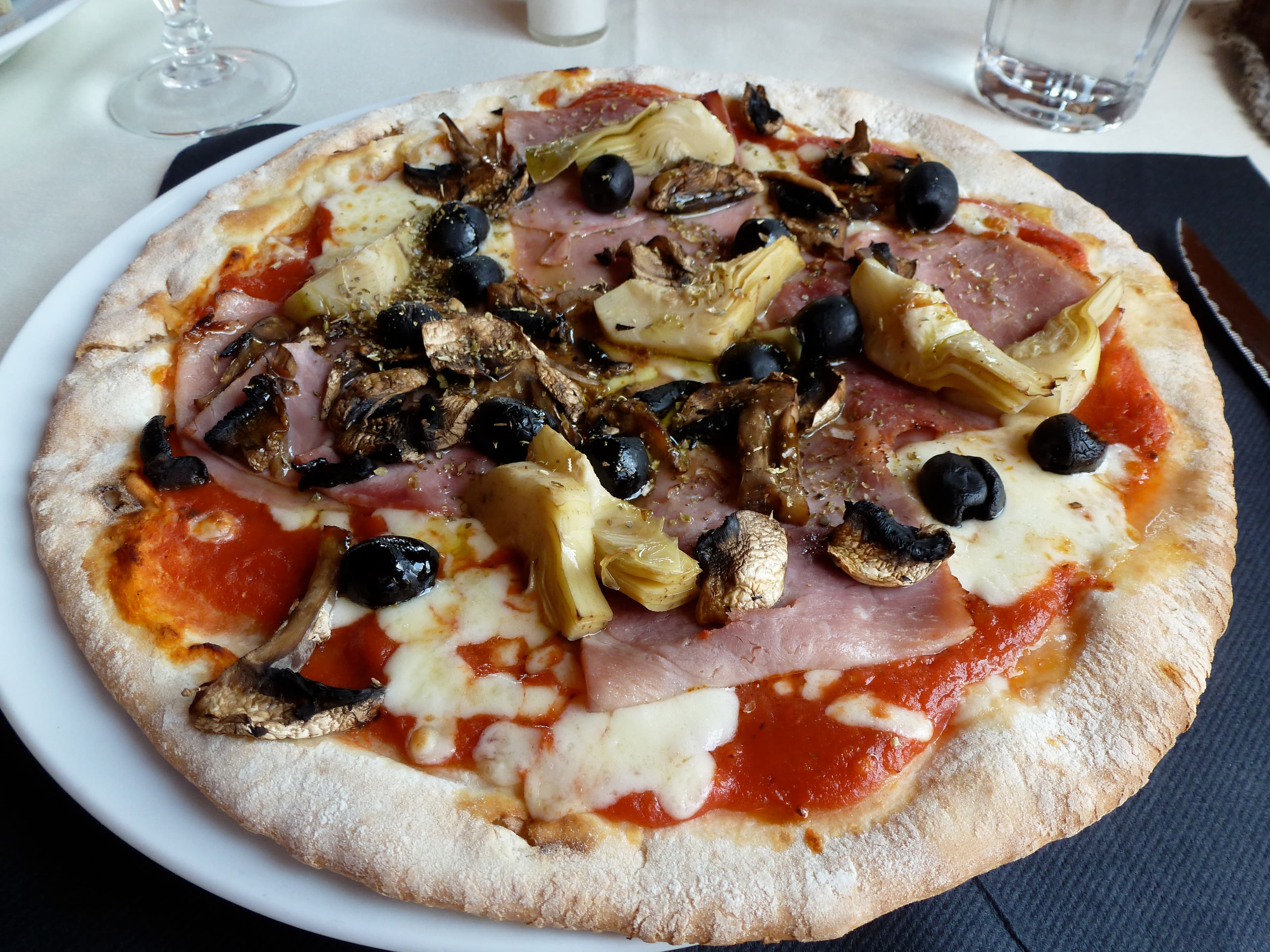 Pizza capricciosa with artichokes ham mushrooms and olives