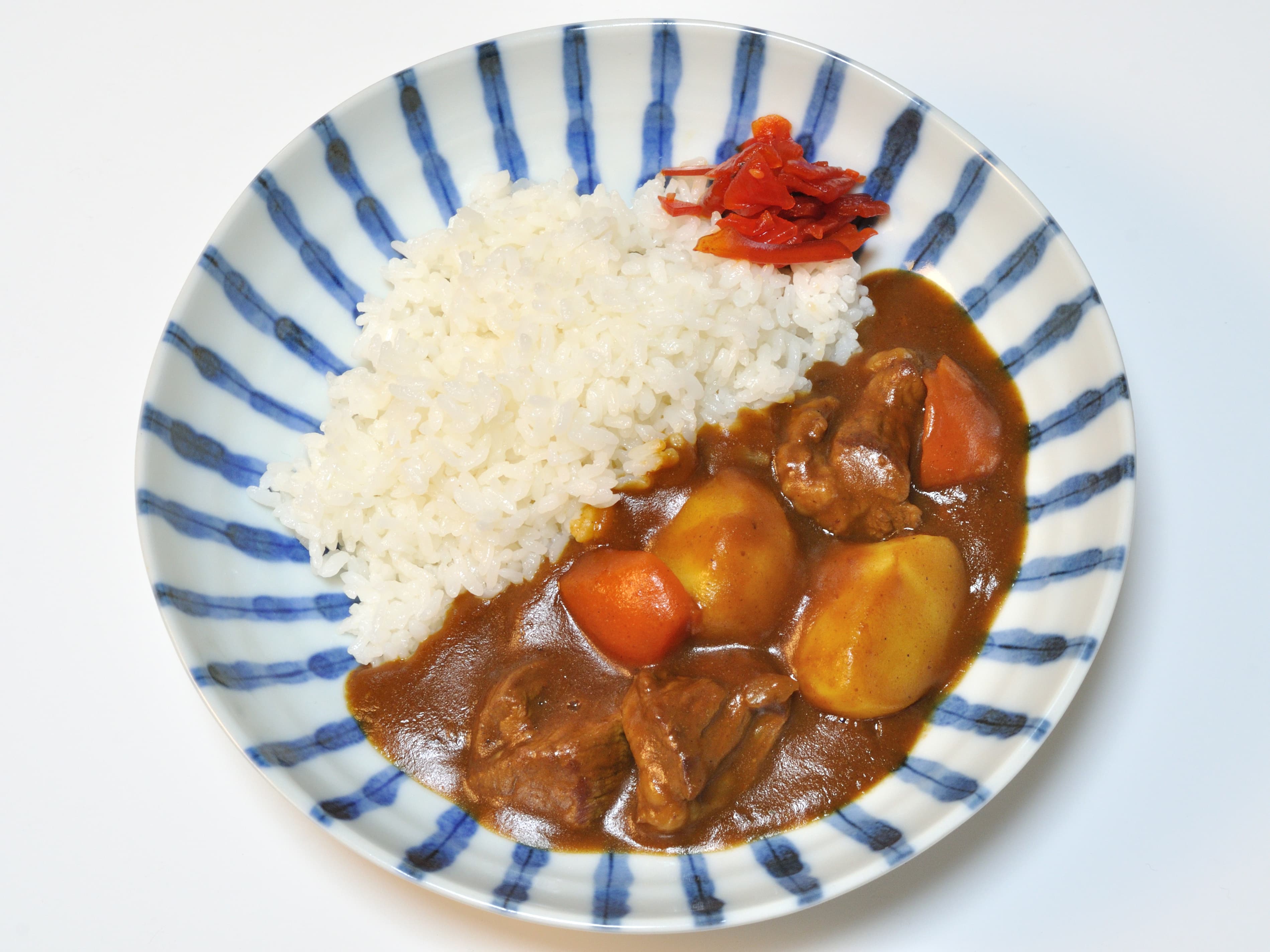 Plate of Japanese curry rice with meat, potatoes, and carrots
