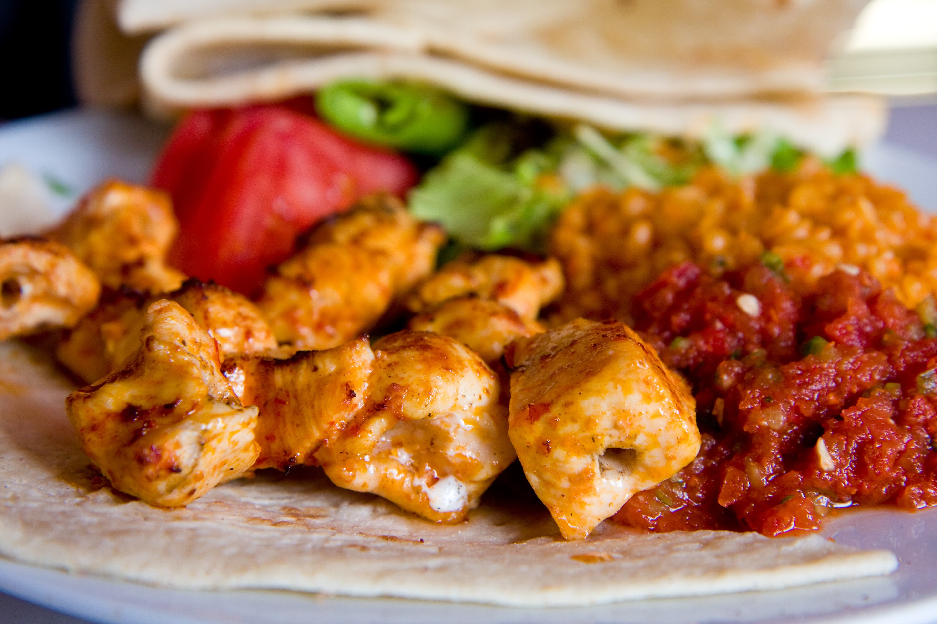 Golden grilled shish tawook chicken skewers with lemon