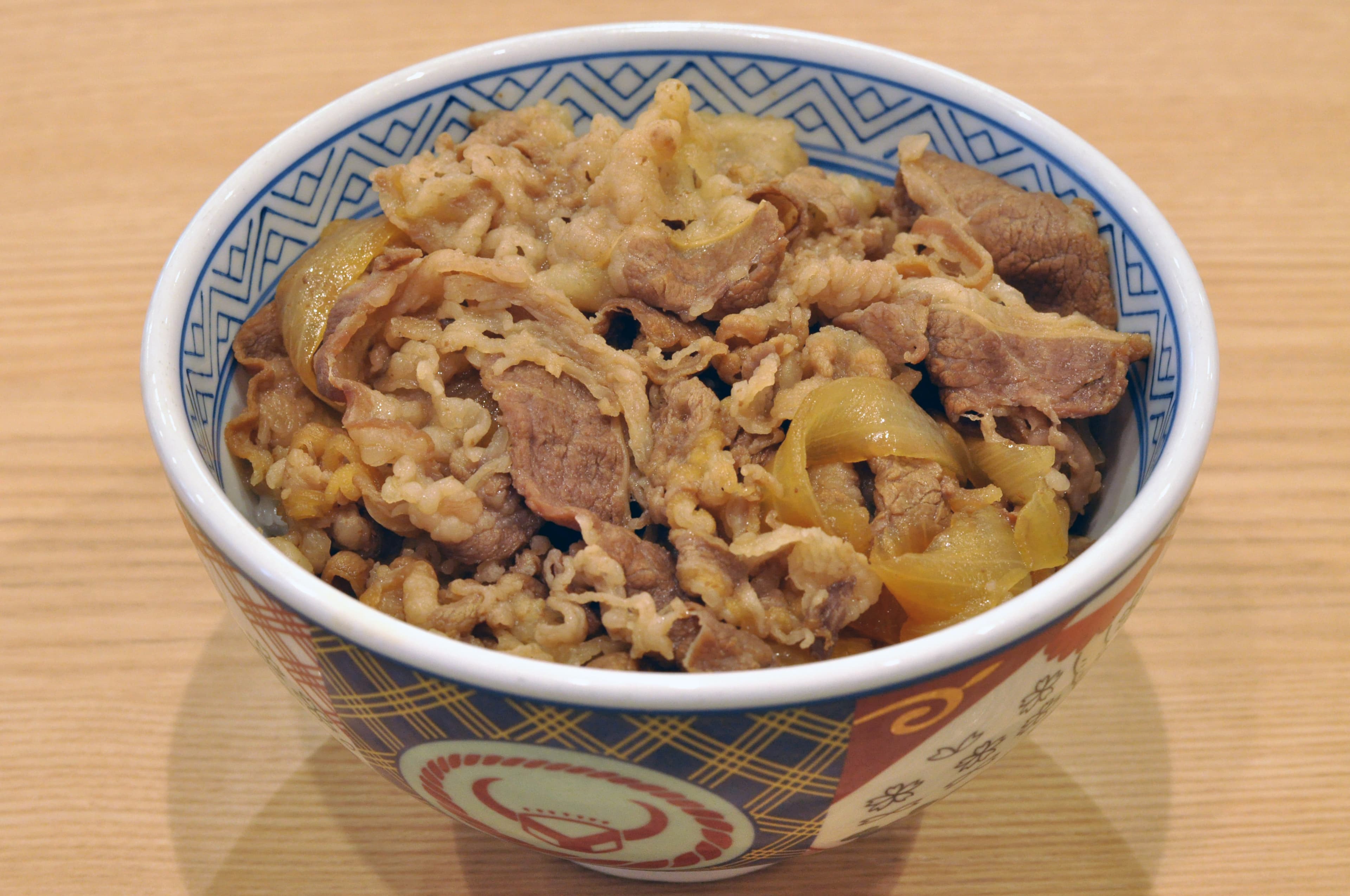 Gyudon beef bowl with onions and pickled ginger over rice