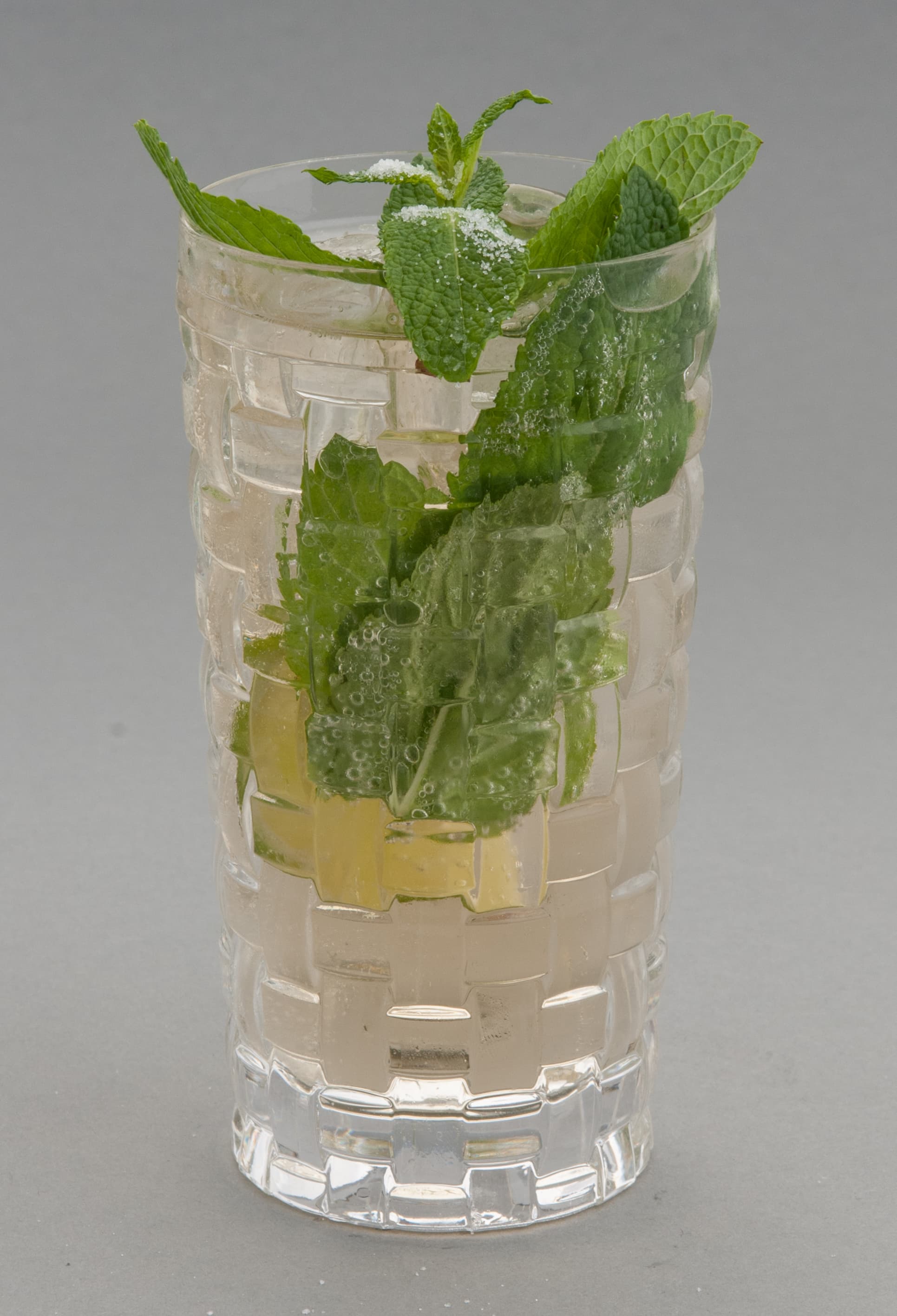 Mojito cocktail with fresh mint and lime in a tall glass
