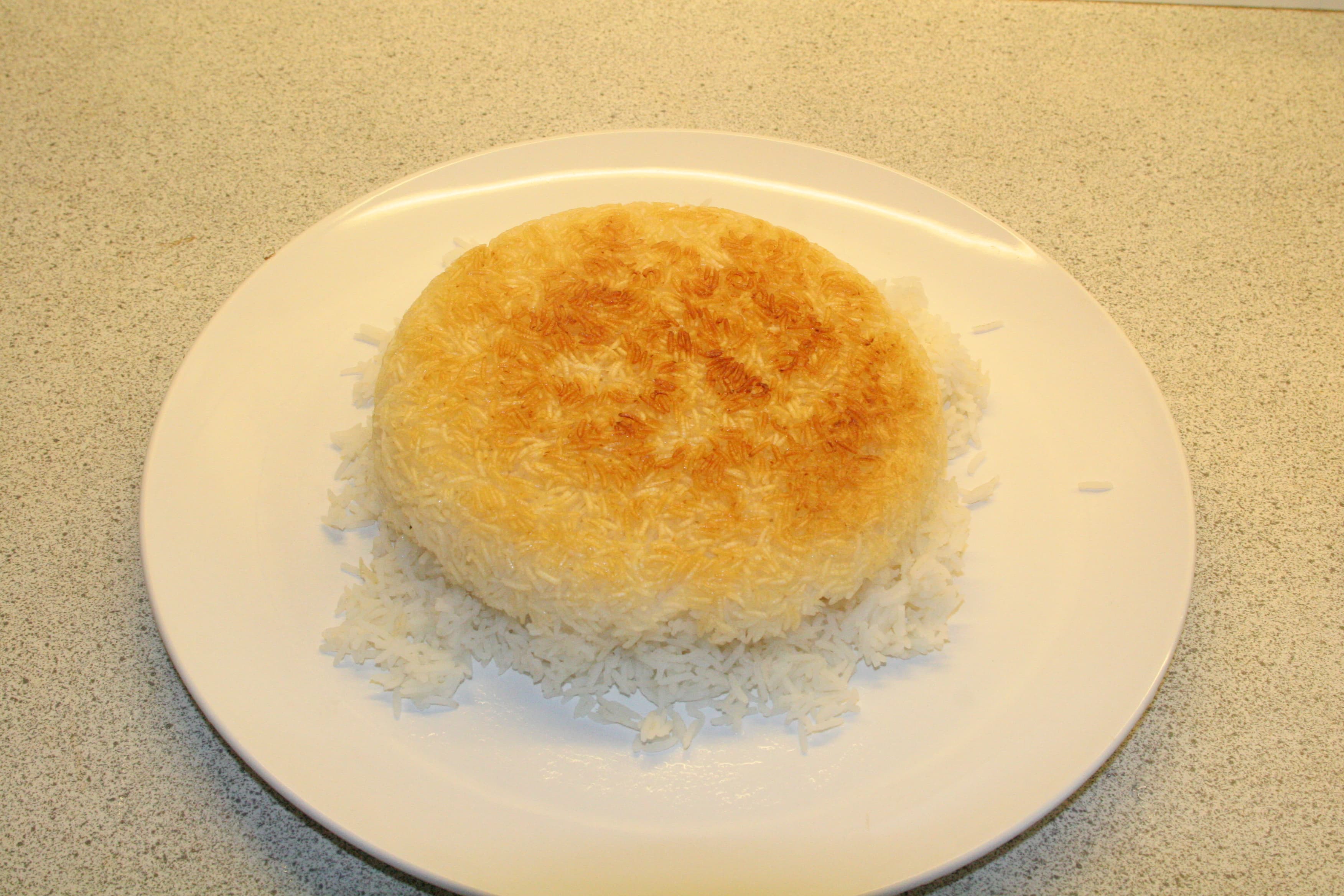 Golden crispy tahdig Persian rice crust inverted on a plate