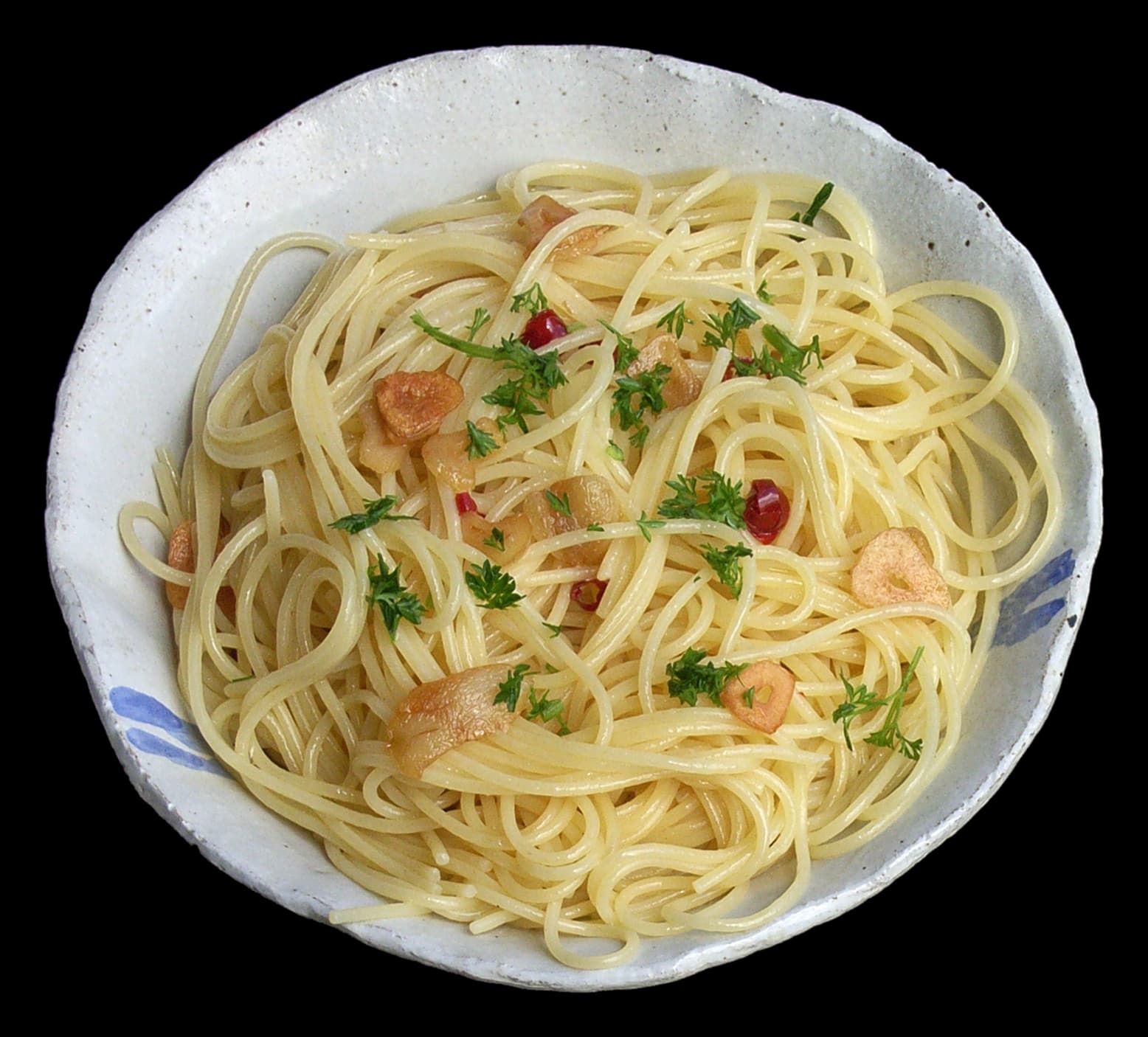 Spaghetti aglio e olio with golden garlic chips and red pepper flakes in a pan