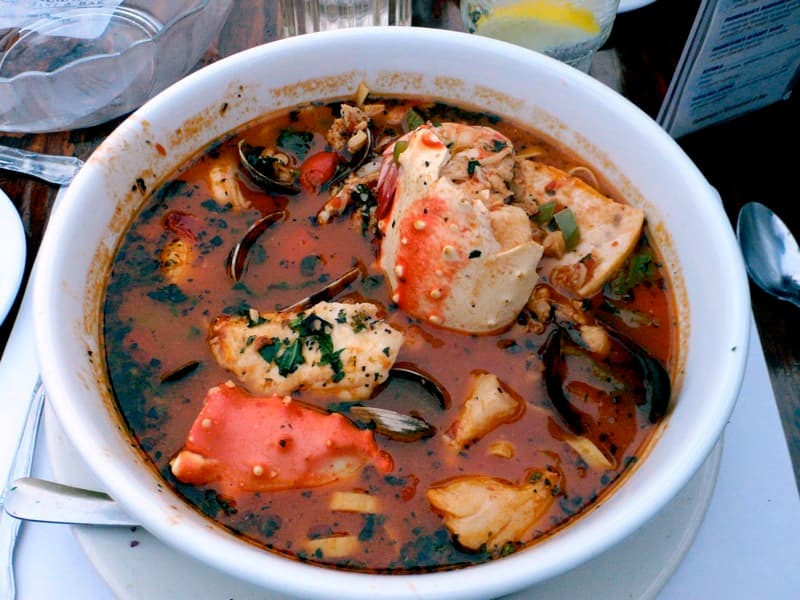 Cioppino seafood stew with clams mussels and shrimp in tomato broth