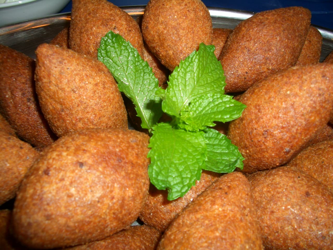 Sliced baked kibbeh showing layers of bulgur shell and lamb filling