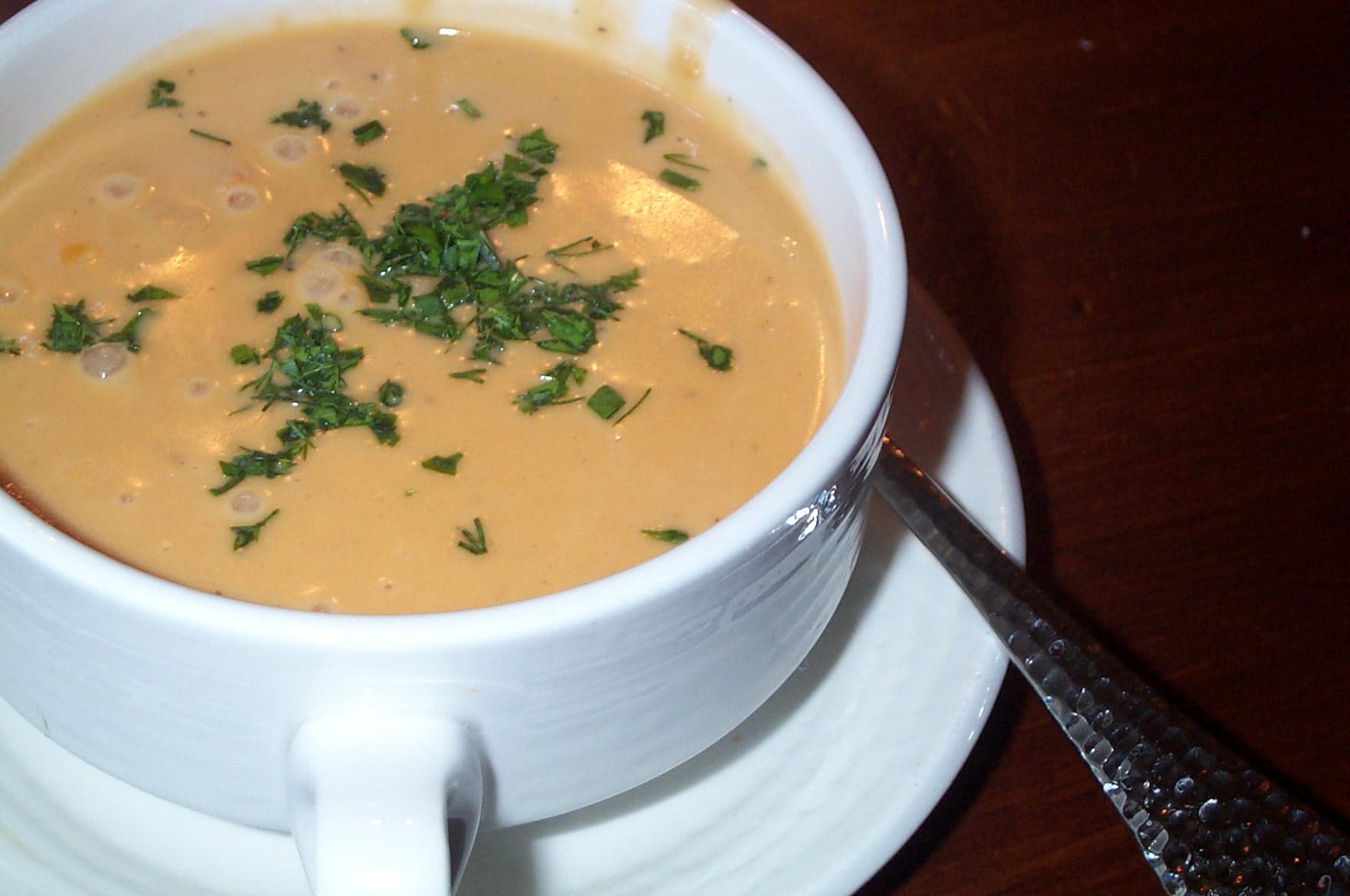 Elegant bowl of lobster bisque garnished with lobster meat and chives