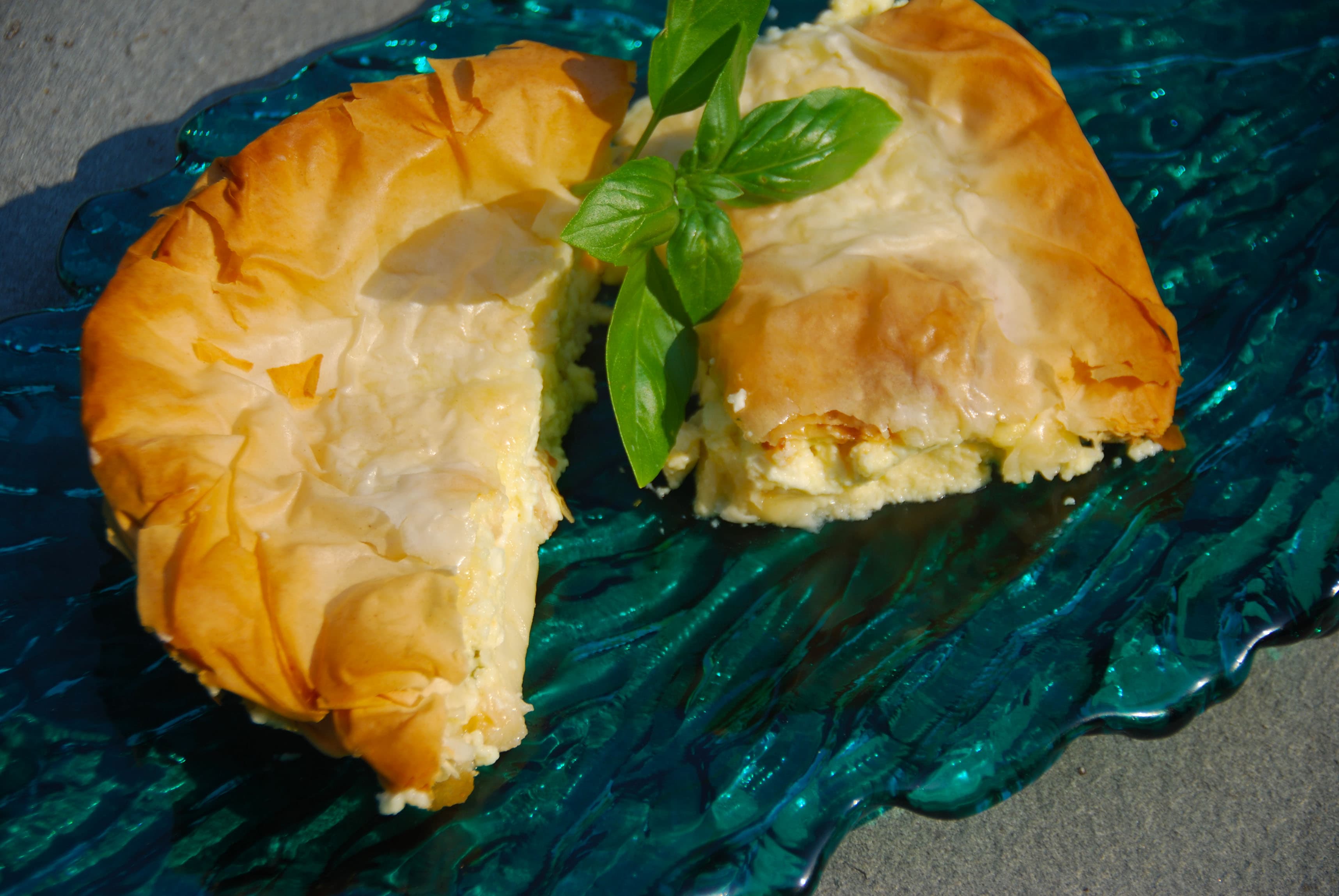 Sliced tiropita cheese pie showing creamy feta filling
