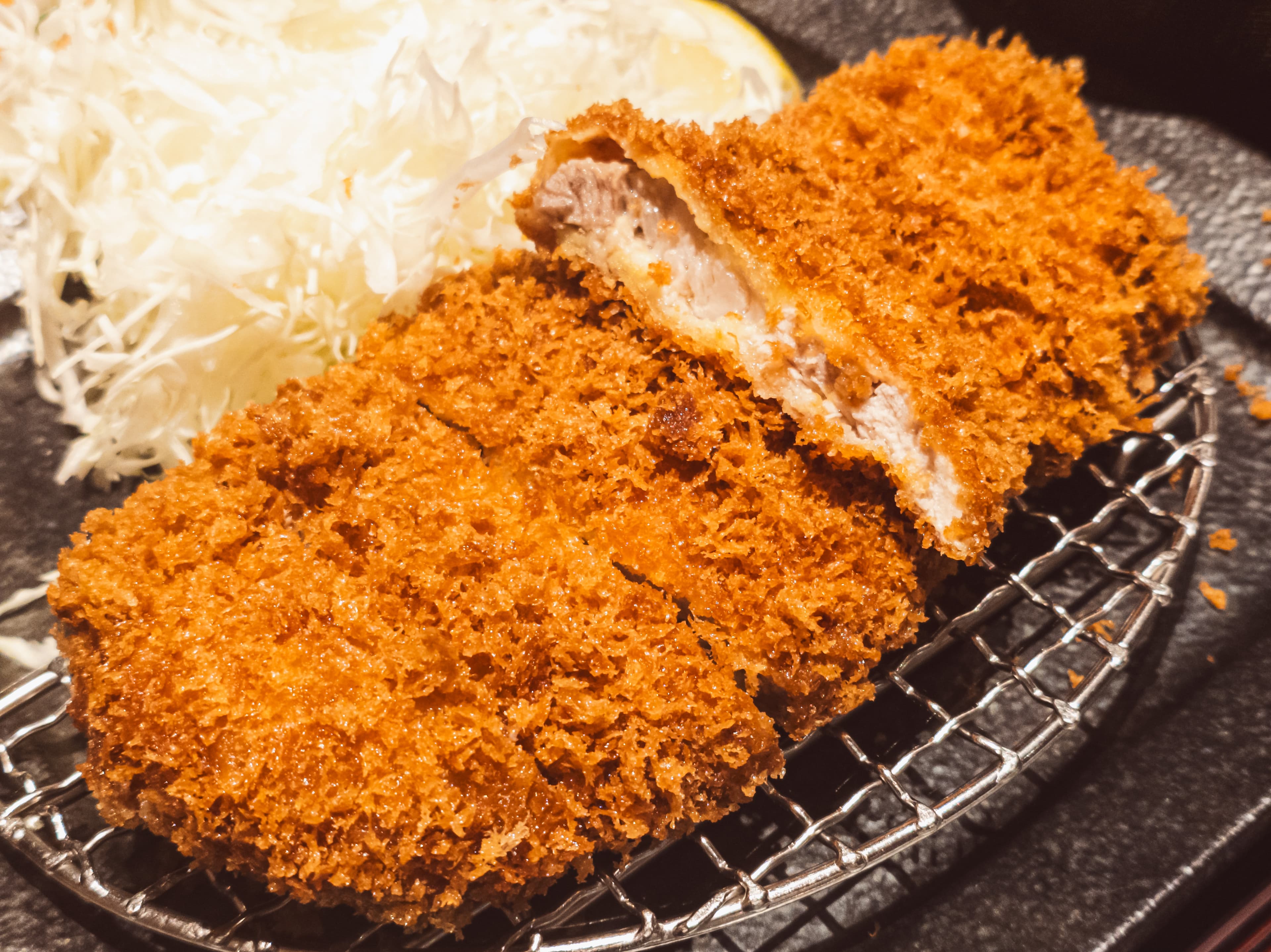 Sliced tonkatsu pork cutlet with shredded cabbage and sauce