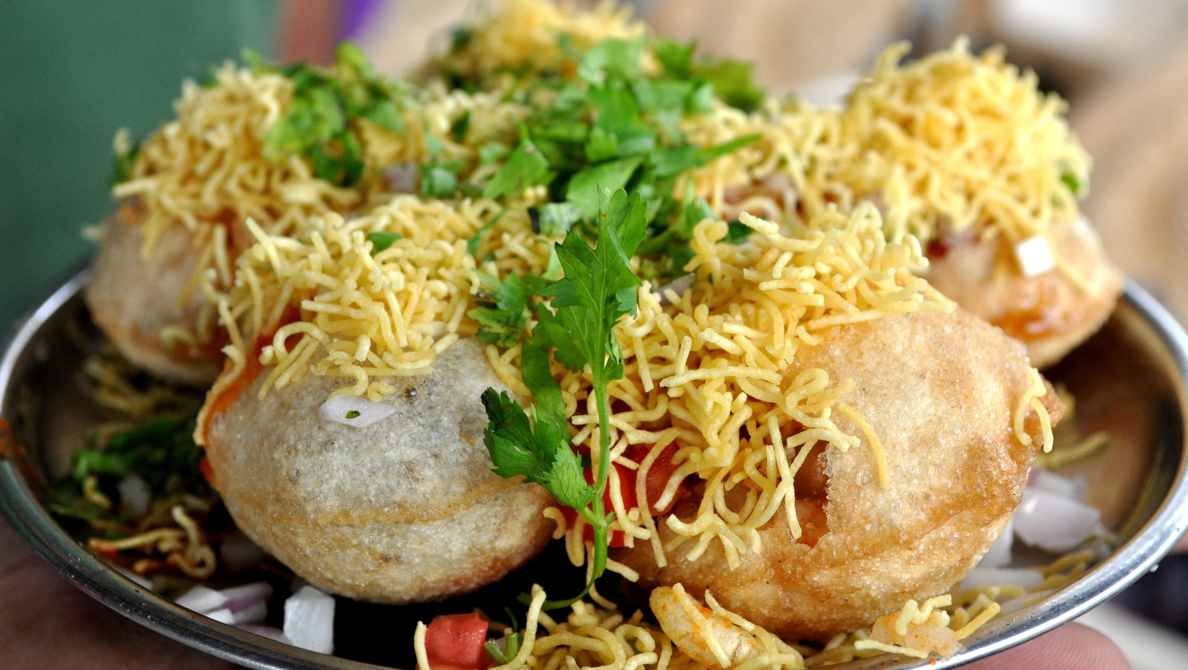 Sev puri chaat with layered toppings and colorful chutneys