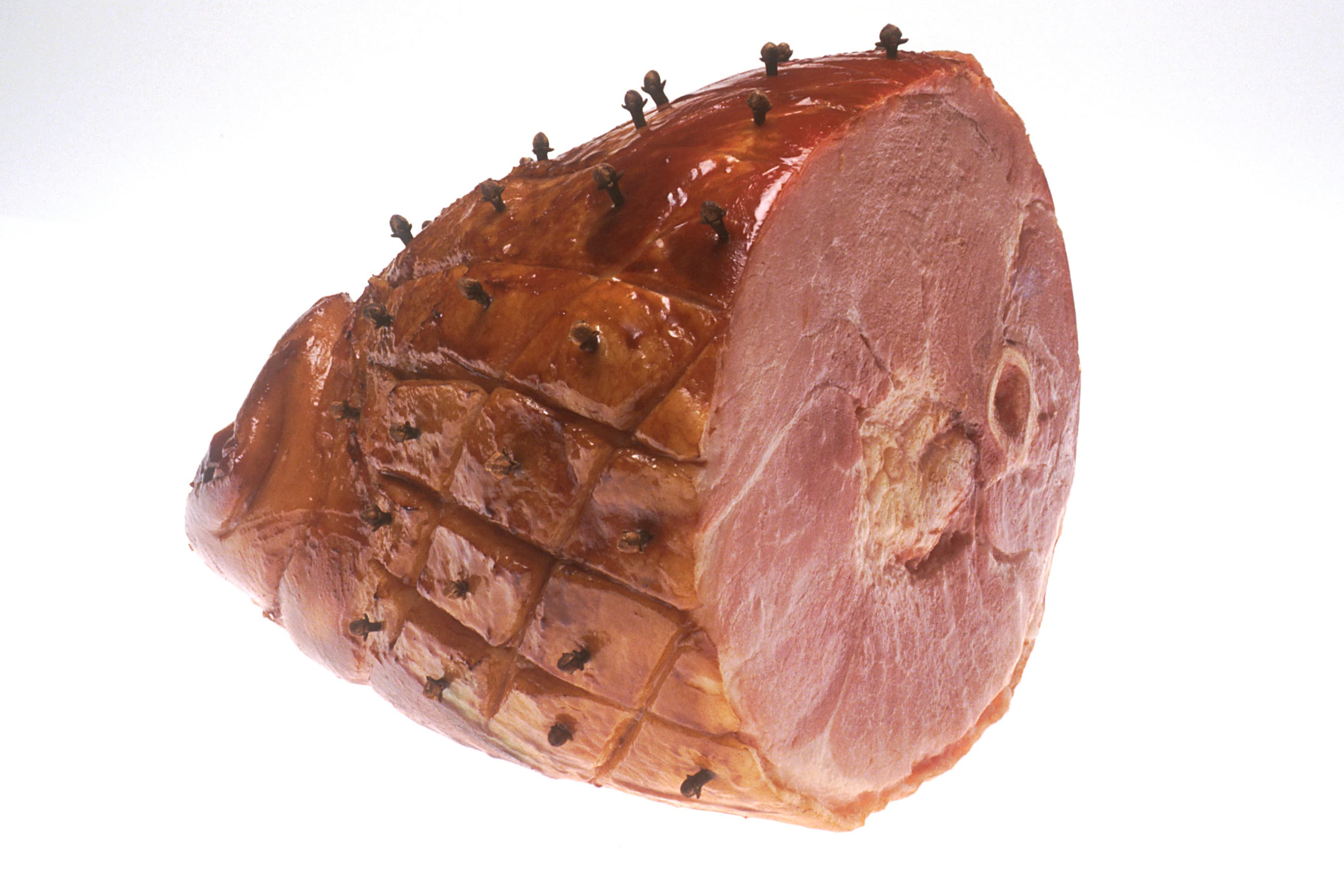 Glazed ham with brown sugar coating sliced on a platter