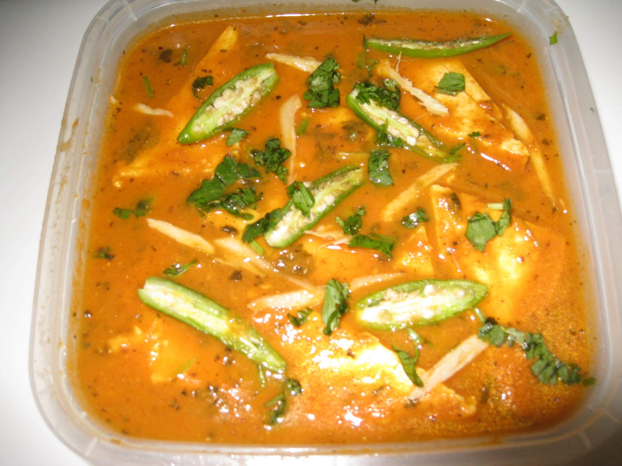 Paneer butter masala in a creamy orange sauce with a swirl of cream
