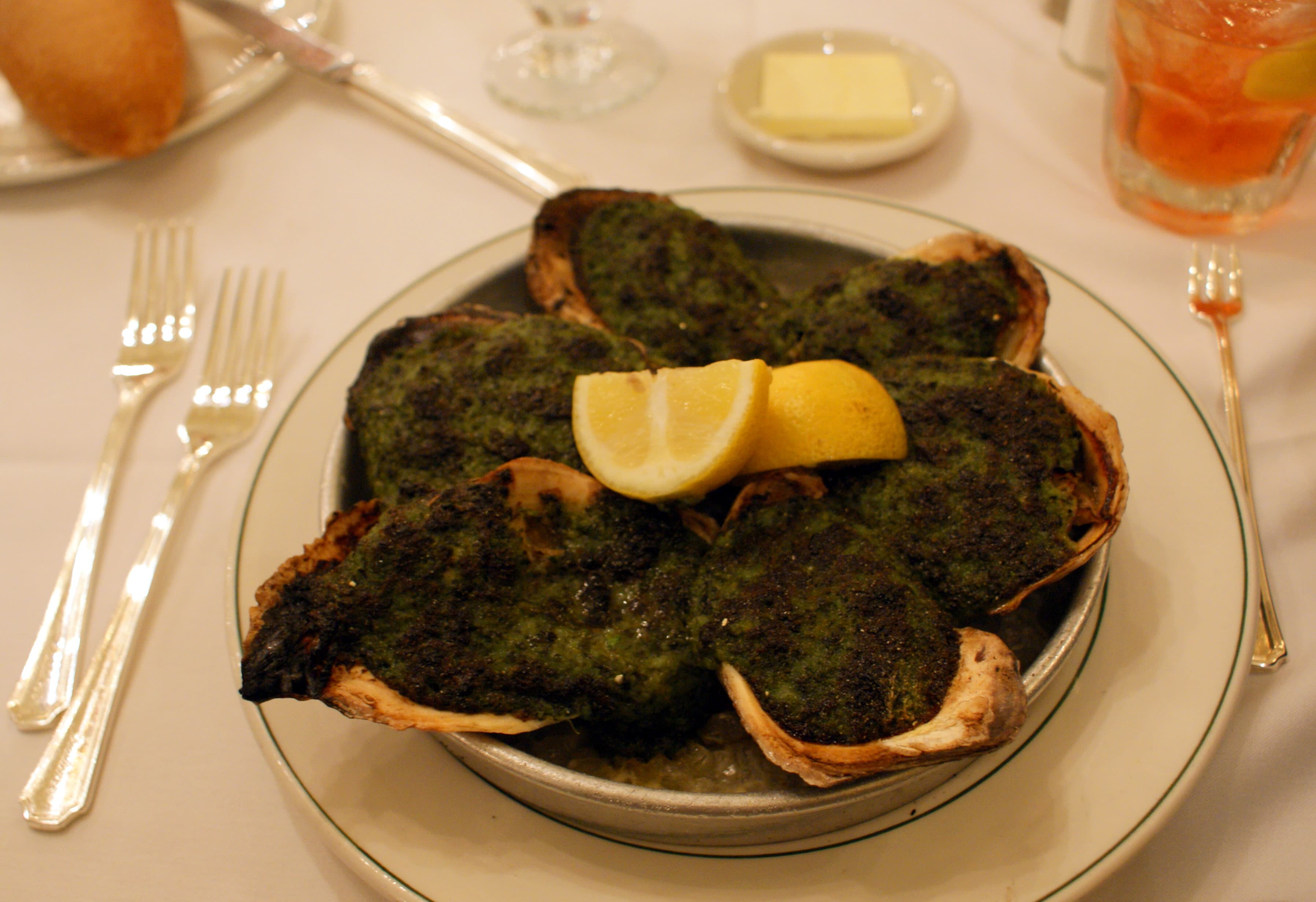 Oysters Rockefeller on a bed of rock salt with golden topping