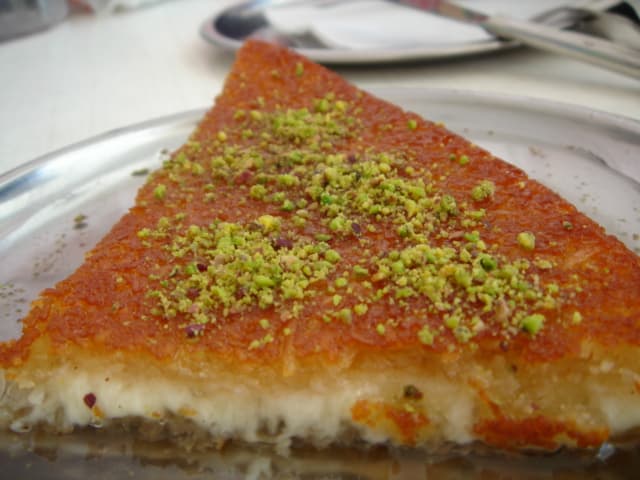 Golden knafeh cheese pastry with orange syrup and pistachios