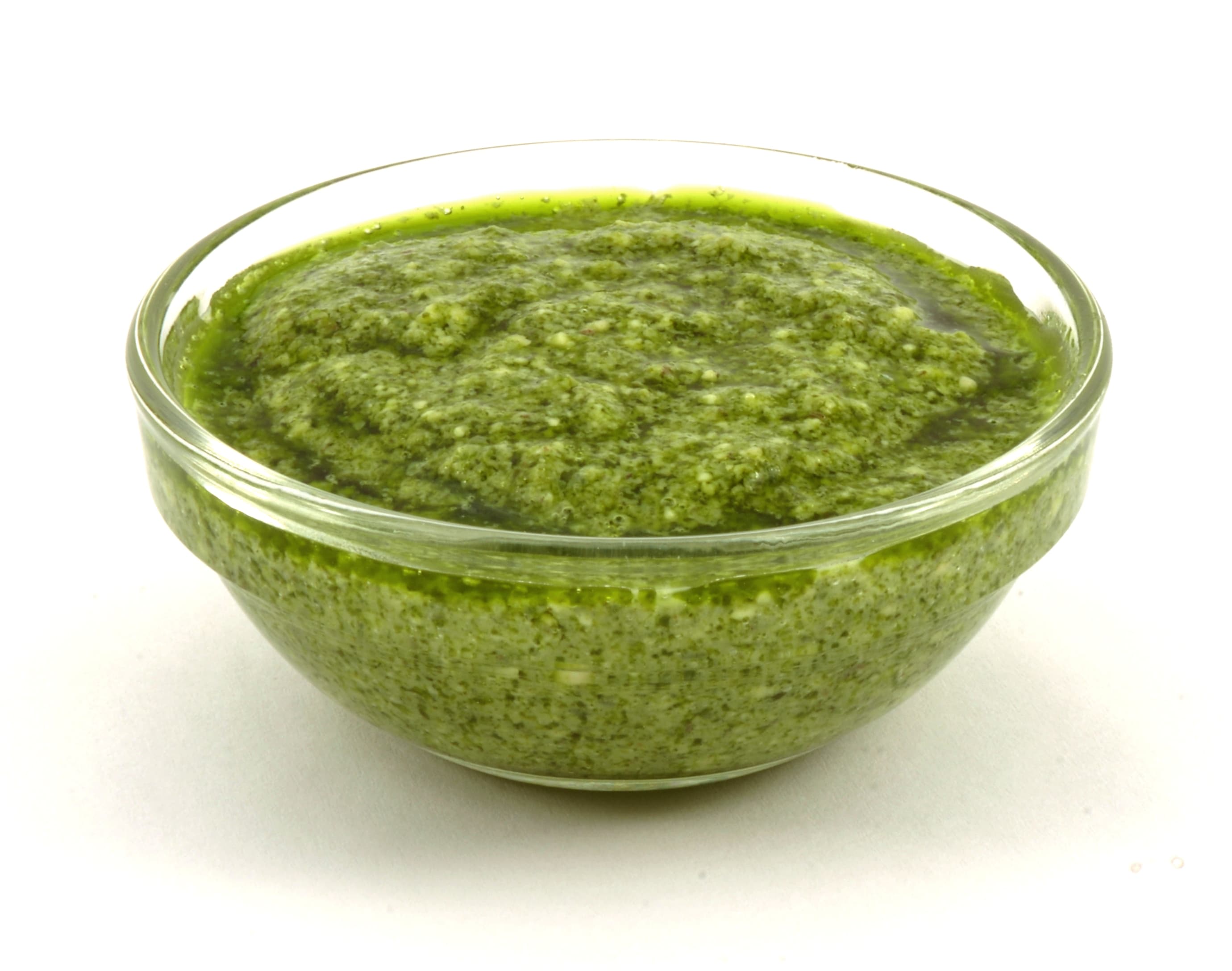 Fresh basil pesto in a mortar with pine nuts and parmesan