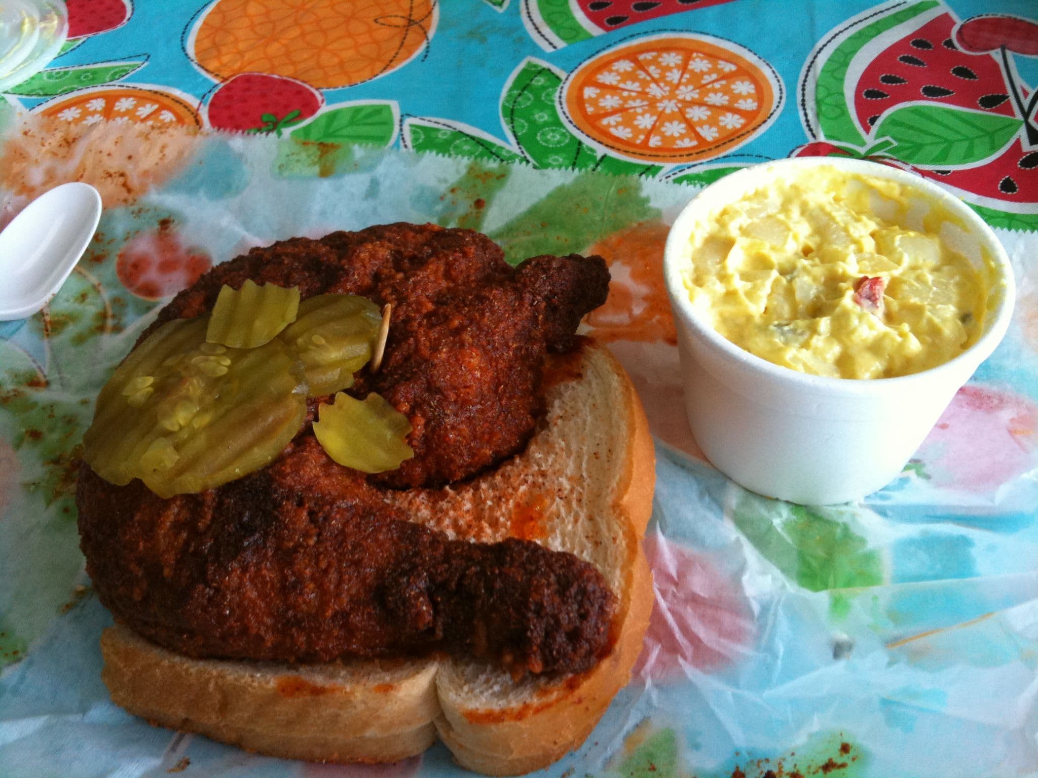 Nashville hot chicken with cayenne glaze on white bread with pickles