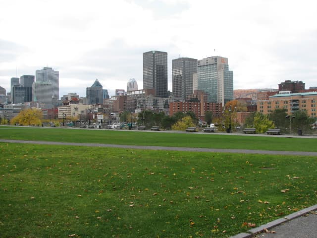 Montreal-style poutine with crisp fries, white cheese curds, and hot brown gravy in a shallow bowl