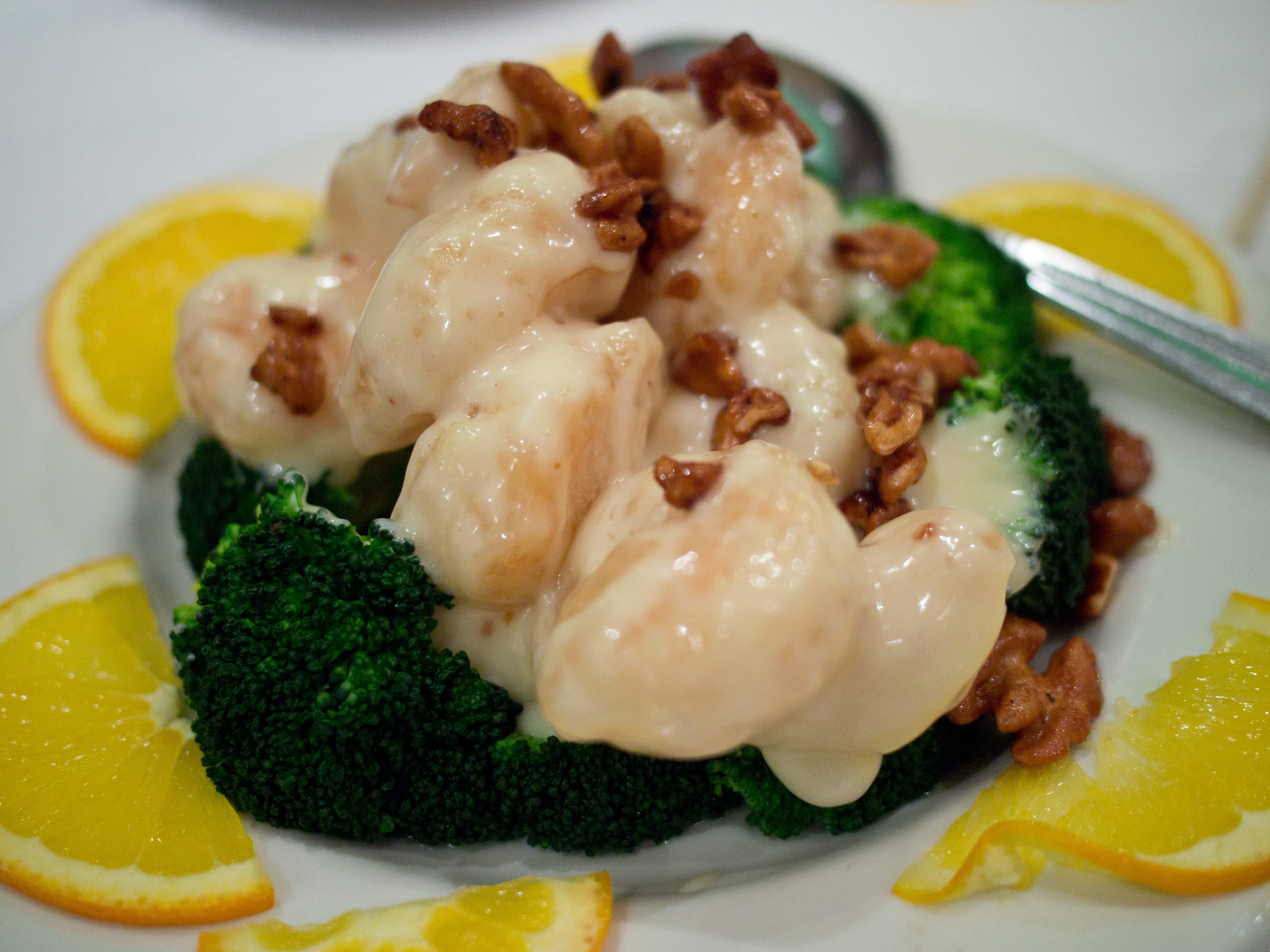 Plate of honey walnut shrimp with candied walnuts and creamy sauce