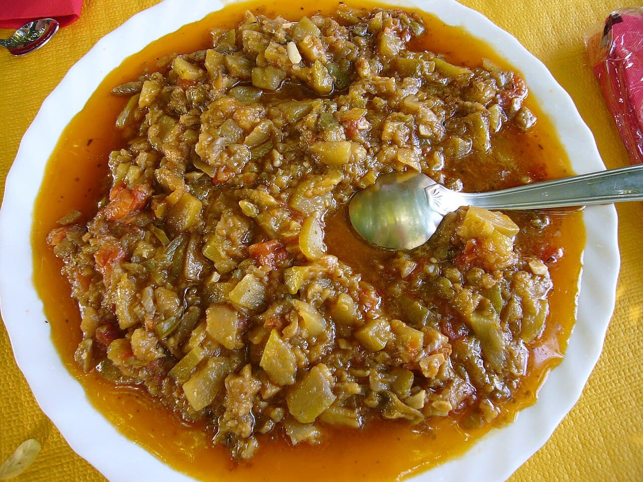 Mushroom bourguignon in a rustic bowl with thyme and crusty bread on the side