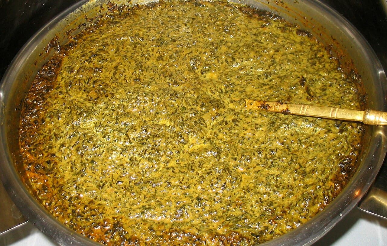 Bowl of sambar with vegetables, served with idli