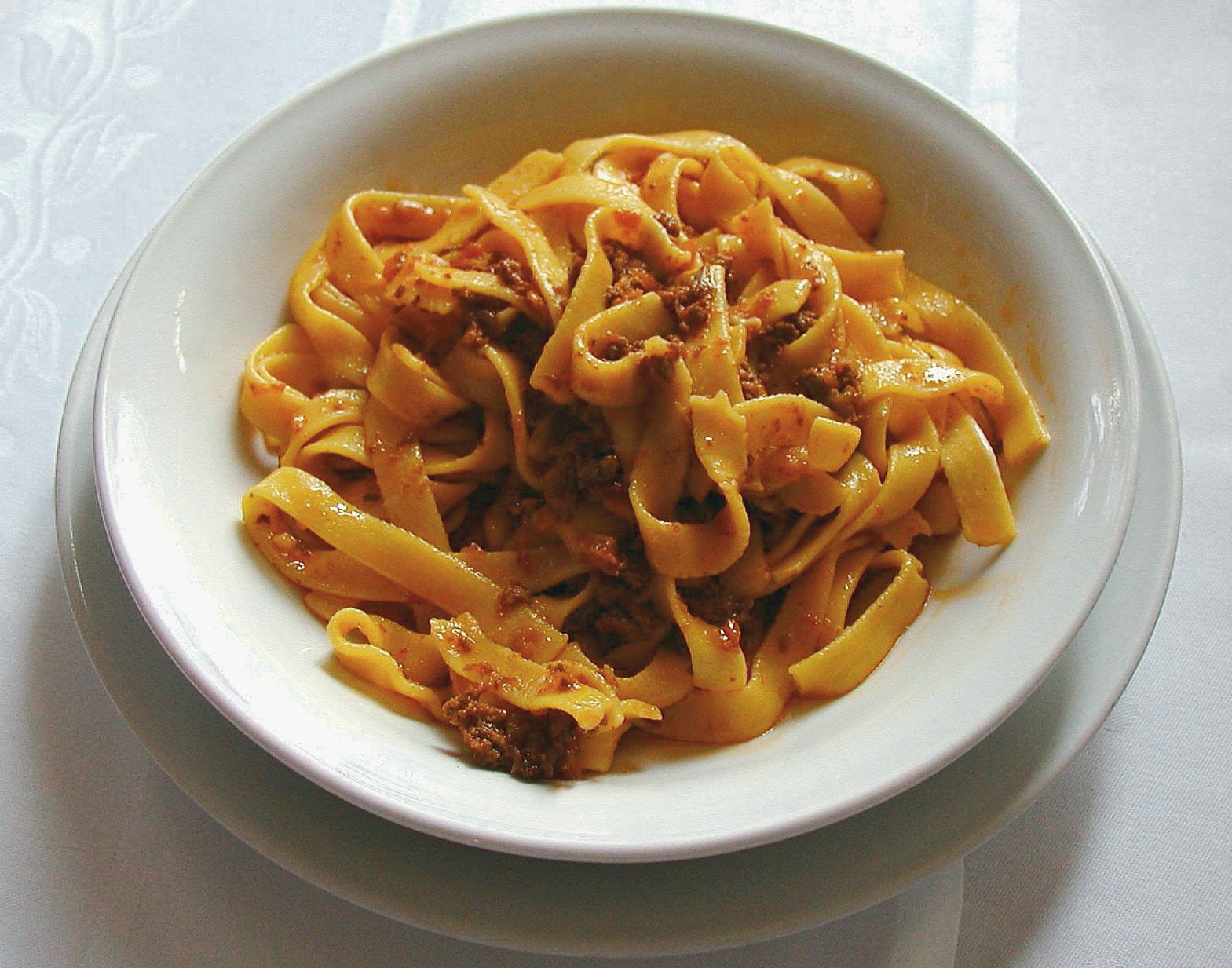 Rich bolognese sauce served over fresh pappardelle pasta